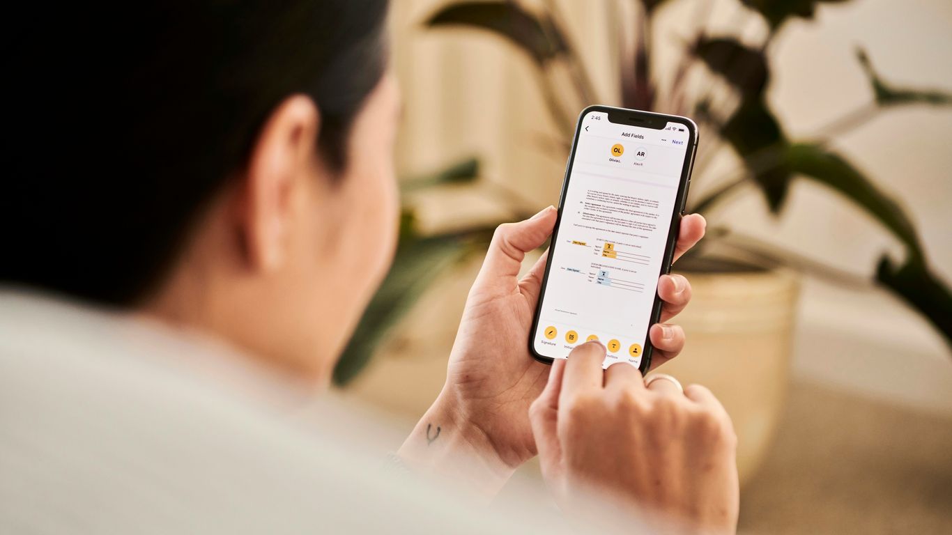 A woman looking at a contract on DocuSign from a iPhone