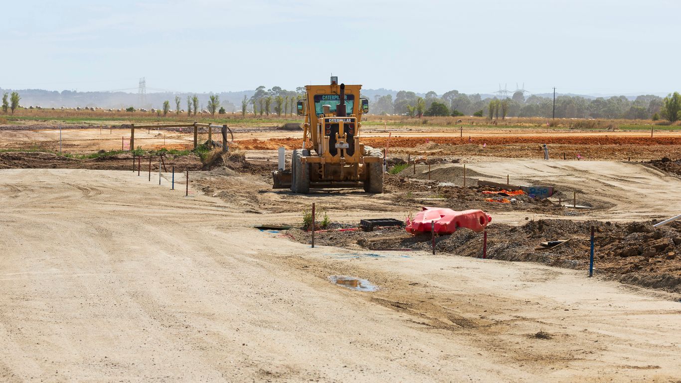 a construction site with a bulldozer in the middle of it