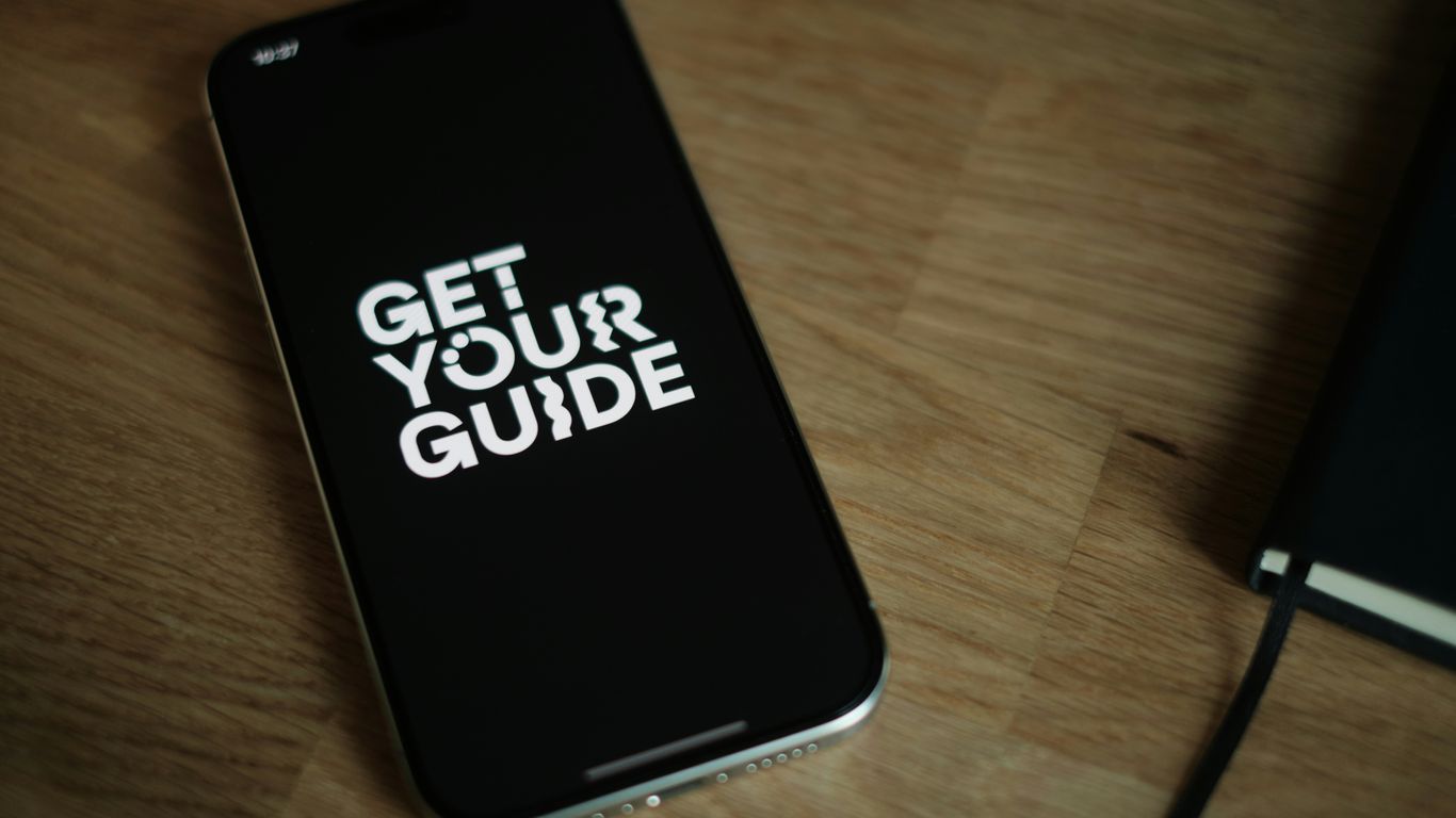 A cell phone sitting on top of a wooden table