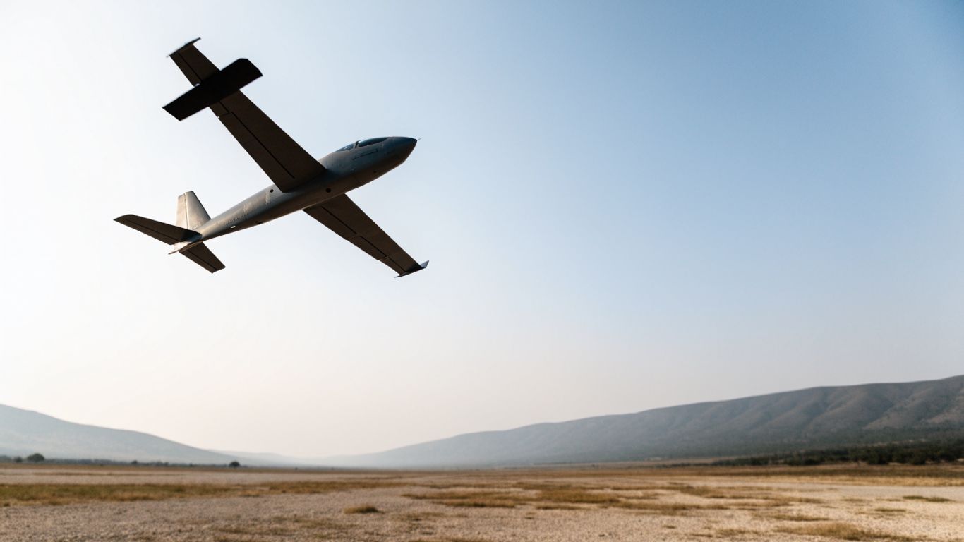 Uncrewed aircraft flying above open terrain