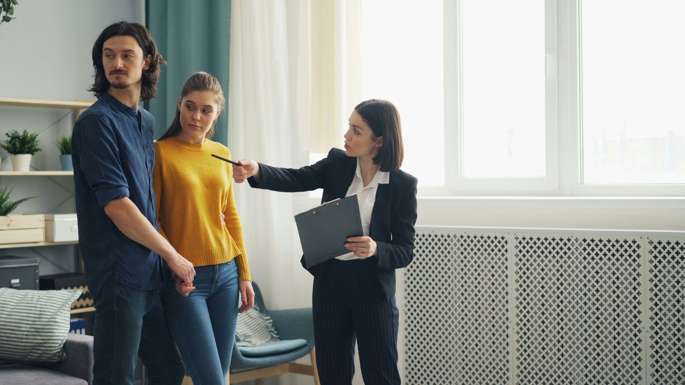 a group of people standing around a living room