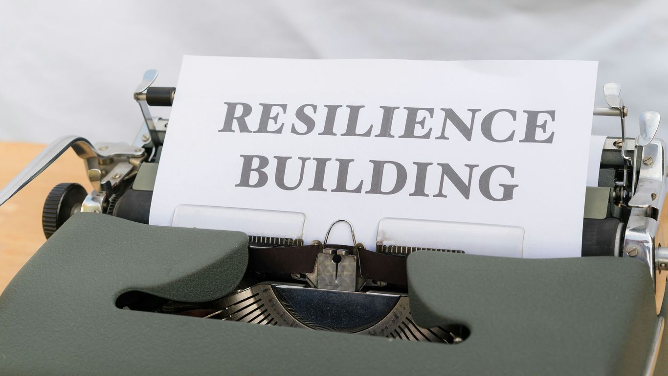 a typewriter with a sign that reads resilince building