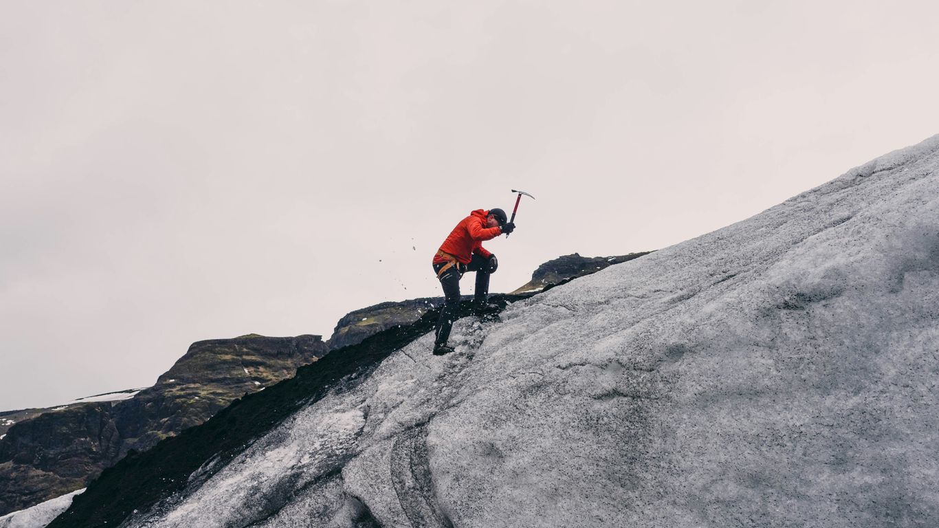 man climbing on mountain during daytime