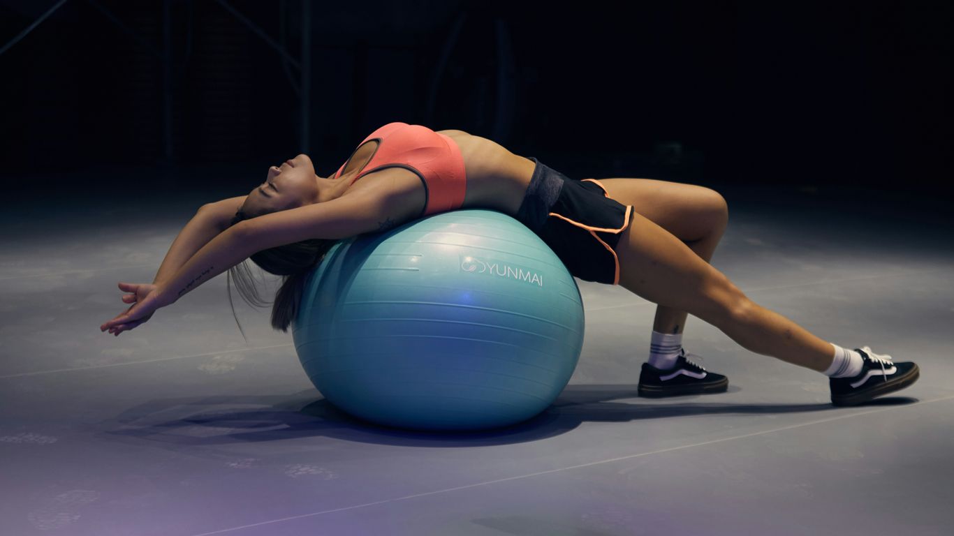 A organized workspace featuring a blue ball chair