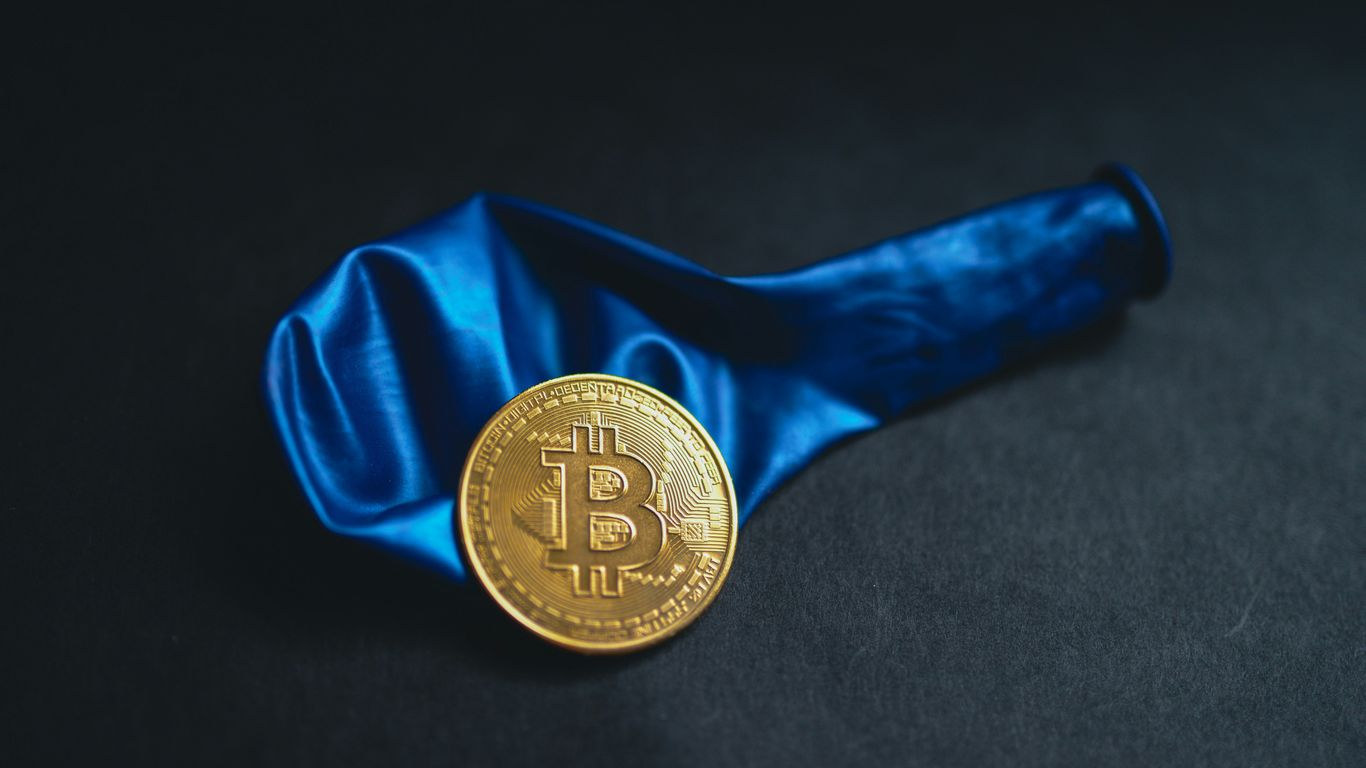 a bitcoin is sitting on a blue cloth
