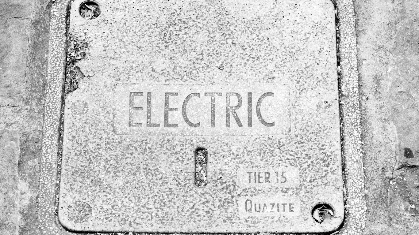 Metal electric utility cover with text.