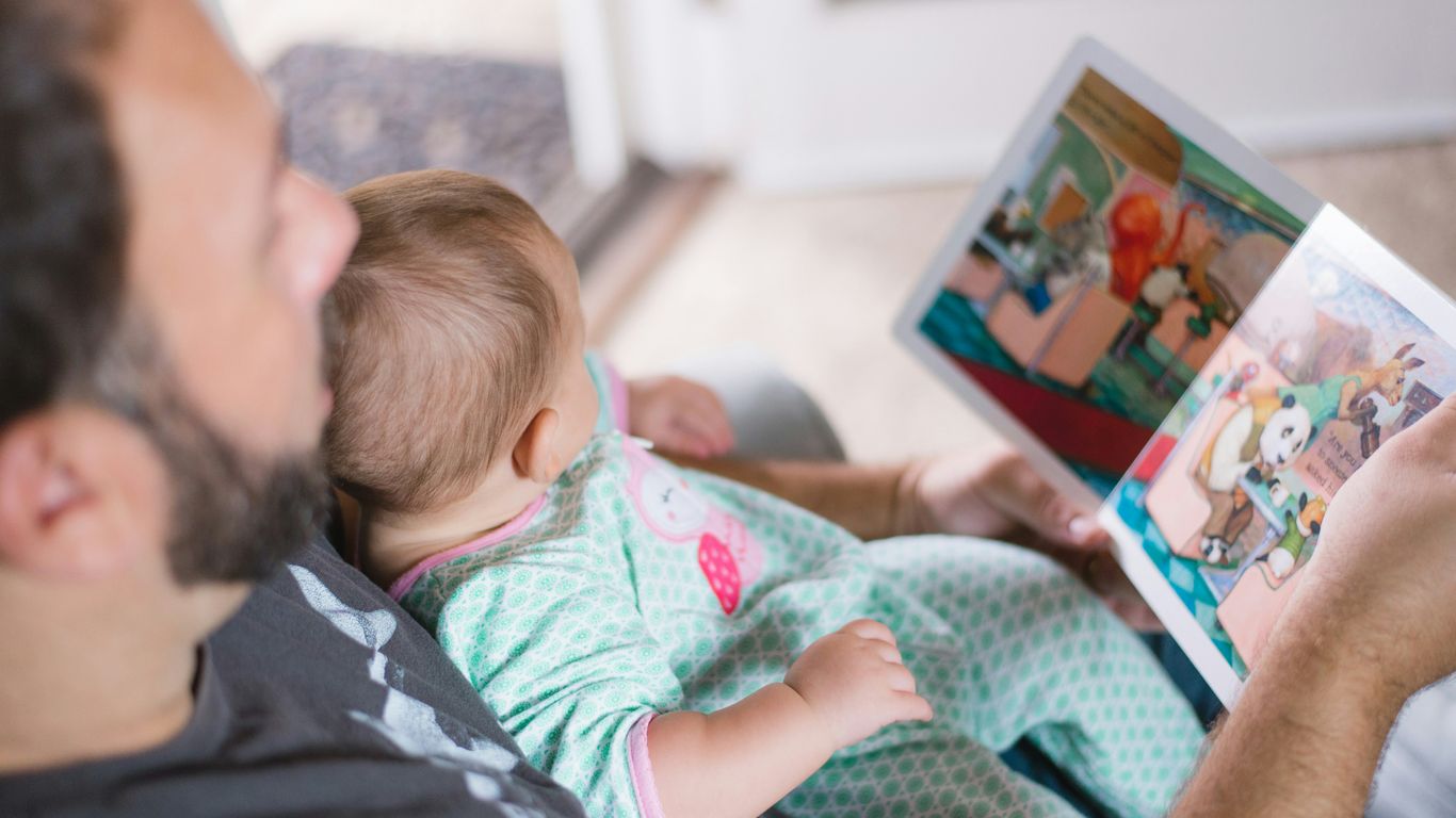 A parent and child browsing books together