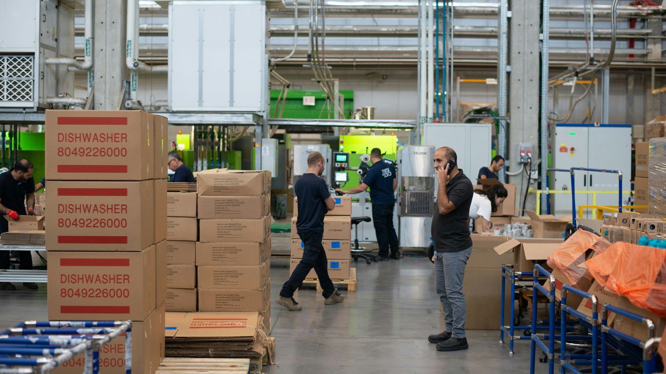 Warehouse staff checking mixed supplier cartons
