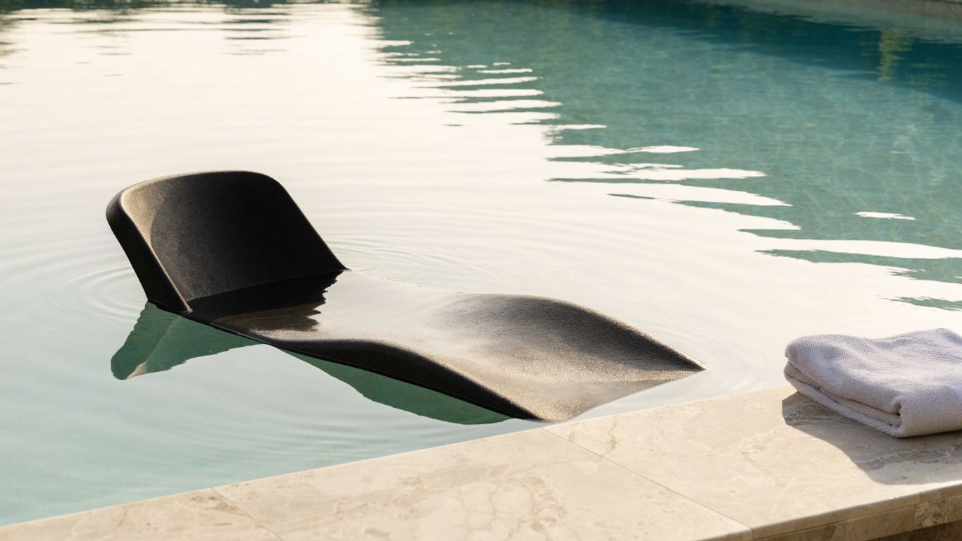 Pool lounge with supportive backrest beside clear water