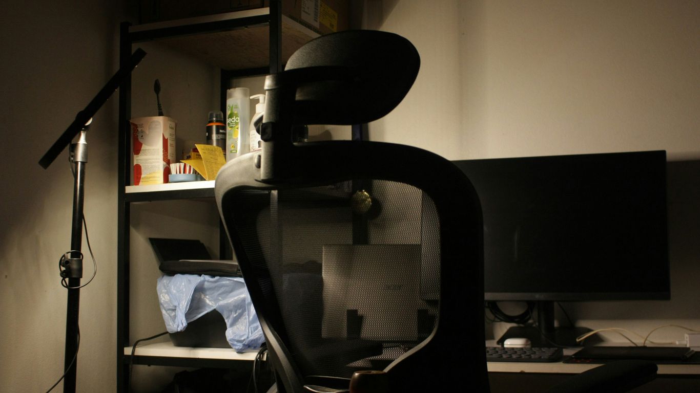 An office chair in front of a computer monitor.