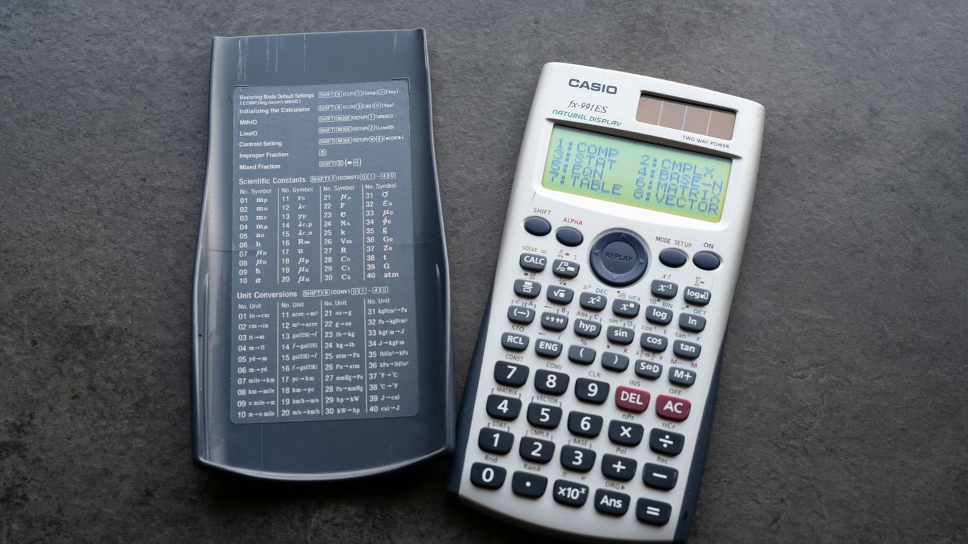 A scientific calculator with its cover open