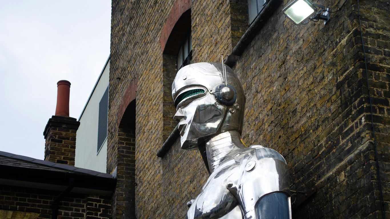 gray concrete statue beside concrete building