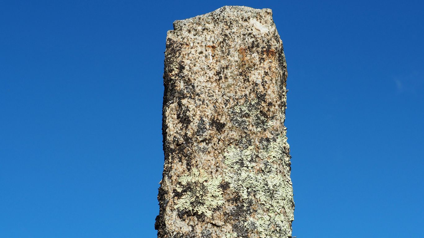 a large rock sticking out of the ground