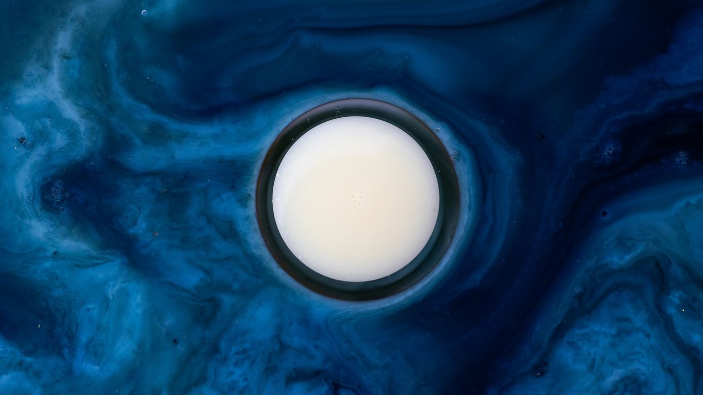 white round container on blue surface