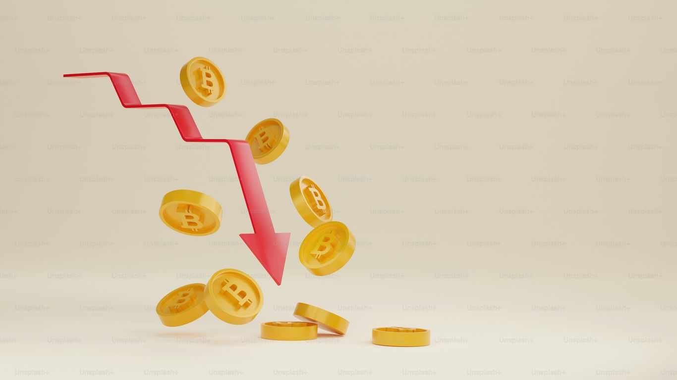 Bitcoin coins falling with a downward trending arrow in background.