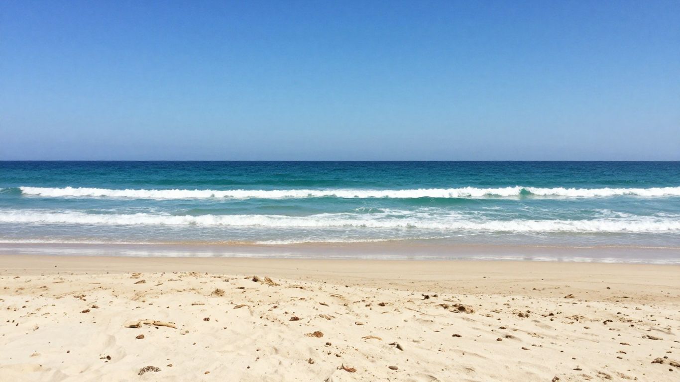 A serene beach scene with tropical blue waters