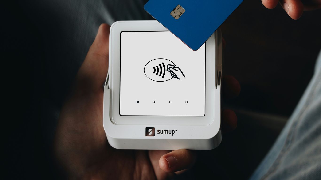 A person holding a credit card in their hand