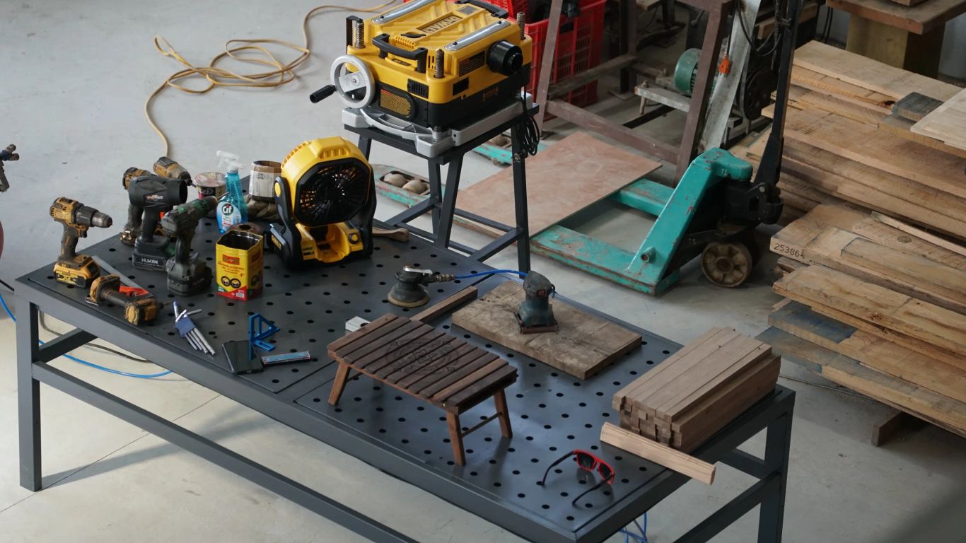Woodworking tools and materials are organized on a workbench.