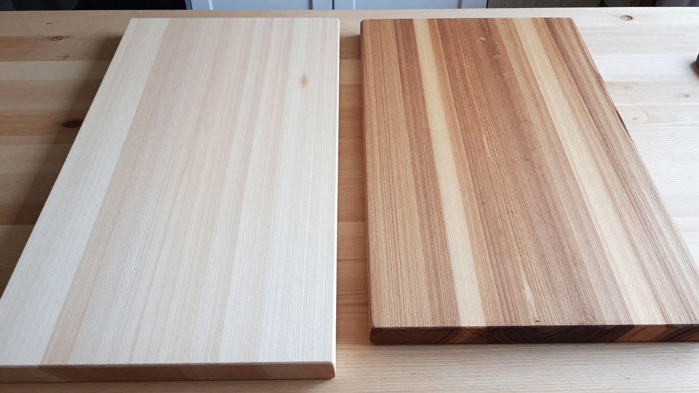 Pale maple lumber beside a striped cutting board
