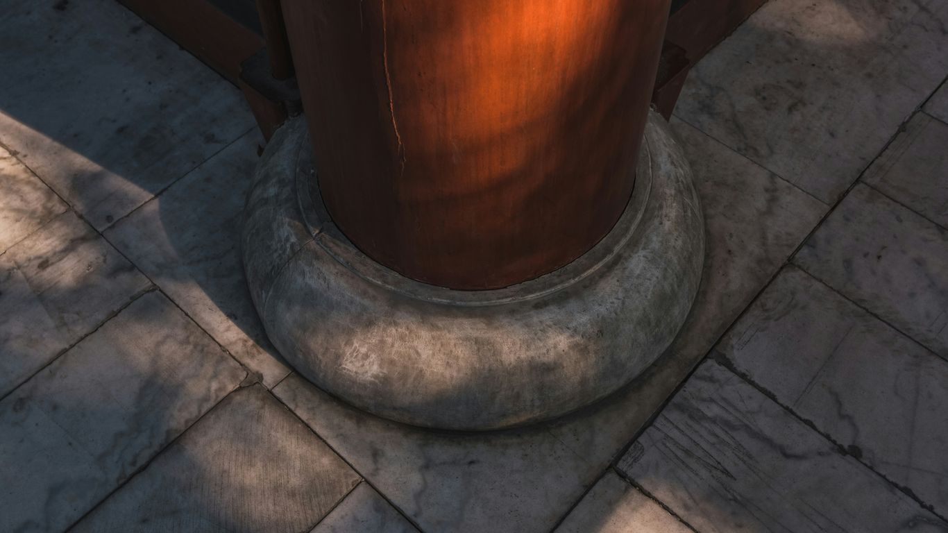 Pedestal base beneath marble dining table