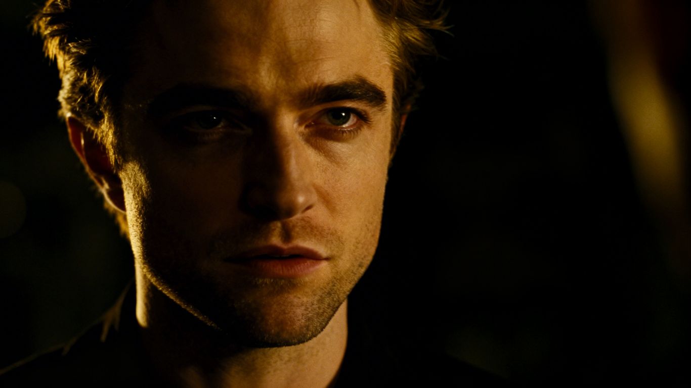 [Robert Pattinson] in a dark, atmospheric portrait.