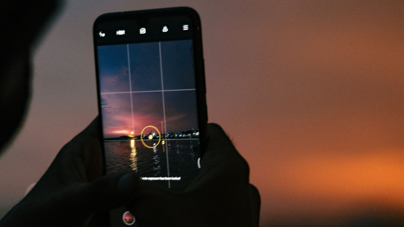 a person taking a picture with a cell phone