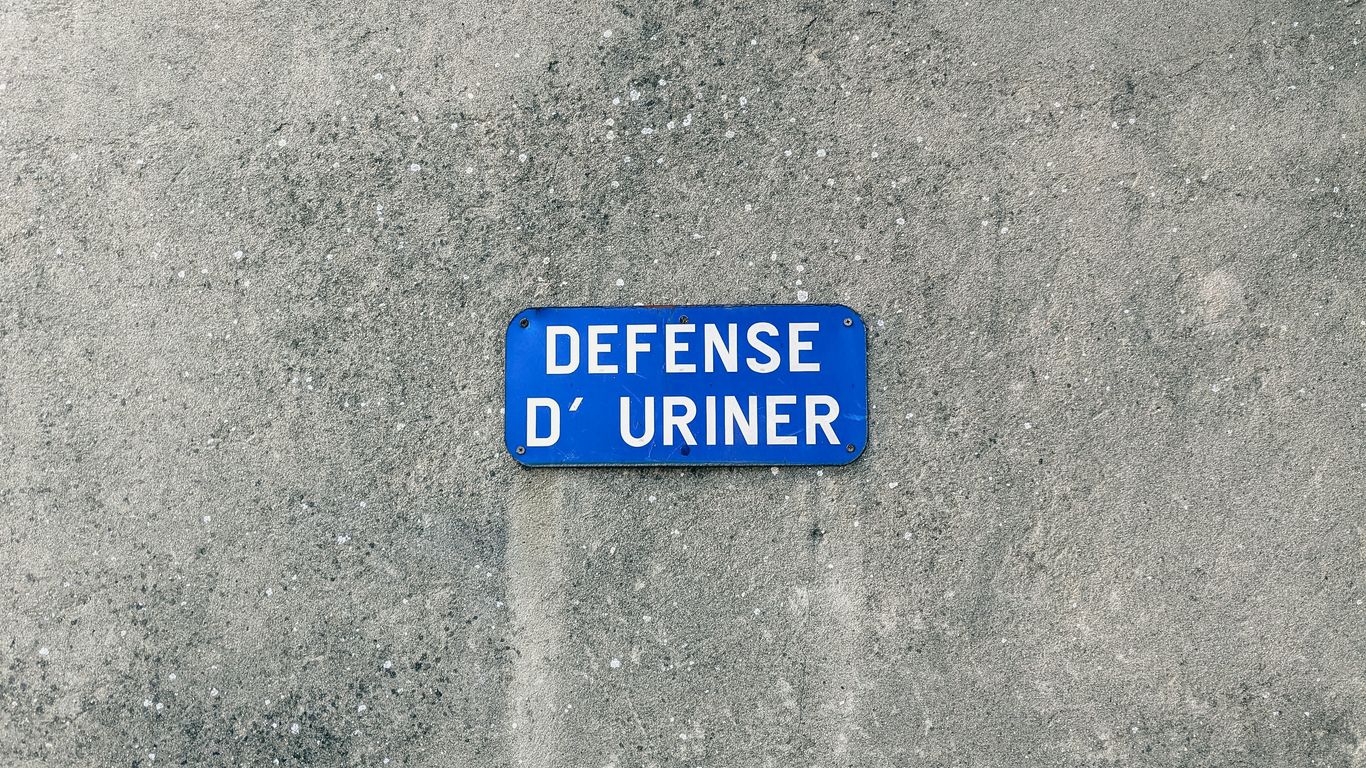a blue street sign sitting on the side of a road