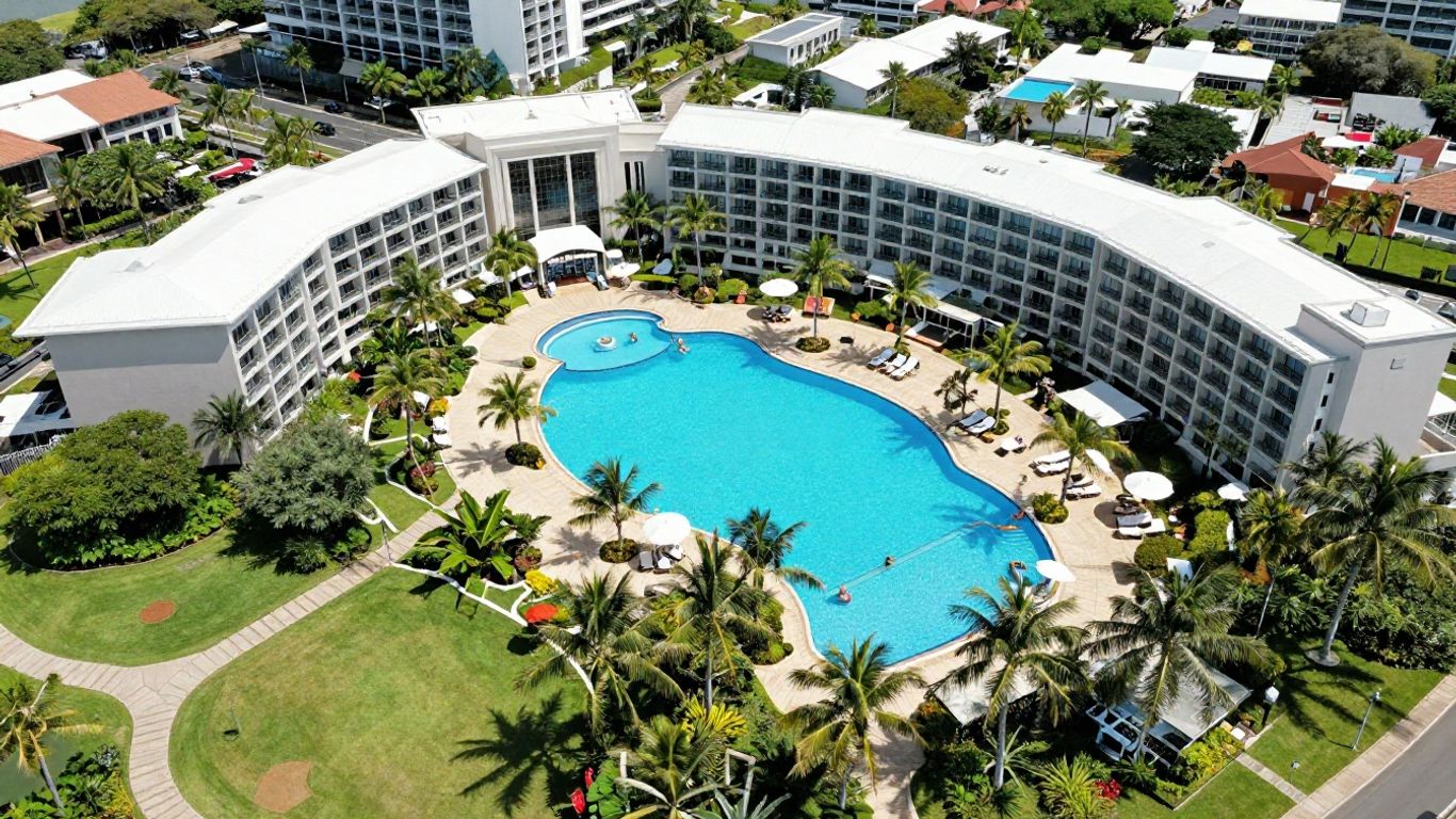 Treasure Island Resort Gold Coast aerial view with pools and palm trees.