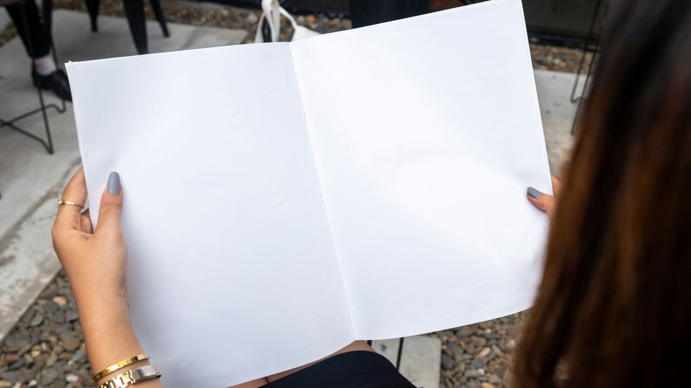 a woman holding a white piece of paper in her hands