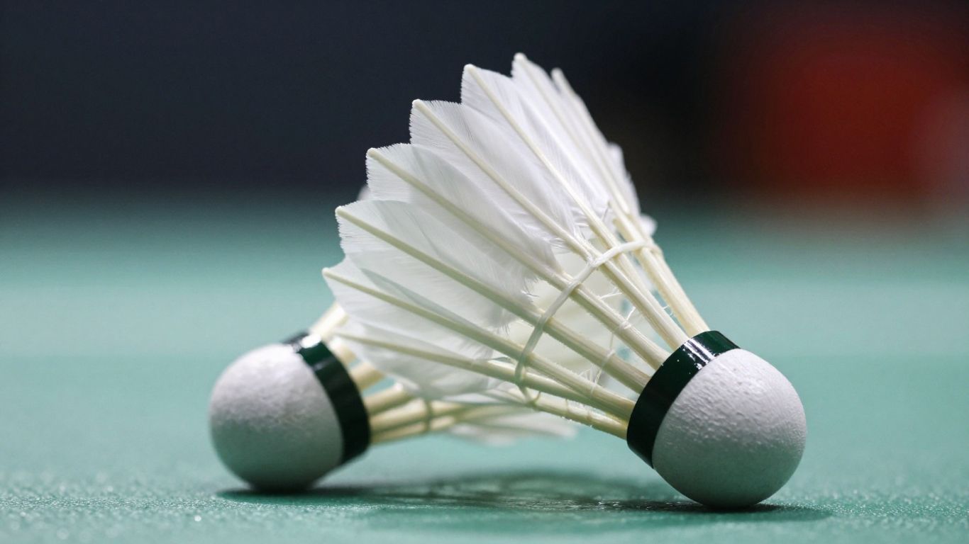 Close-up of a badminton shuttlecock in flight.