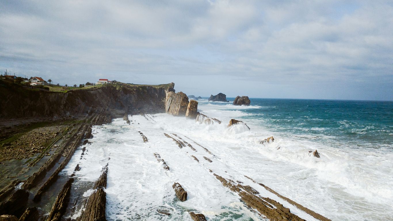 a rocky coastline with waves crashing against the rocks