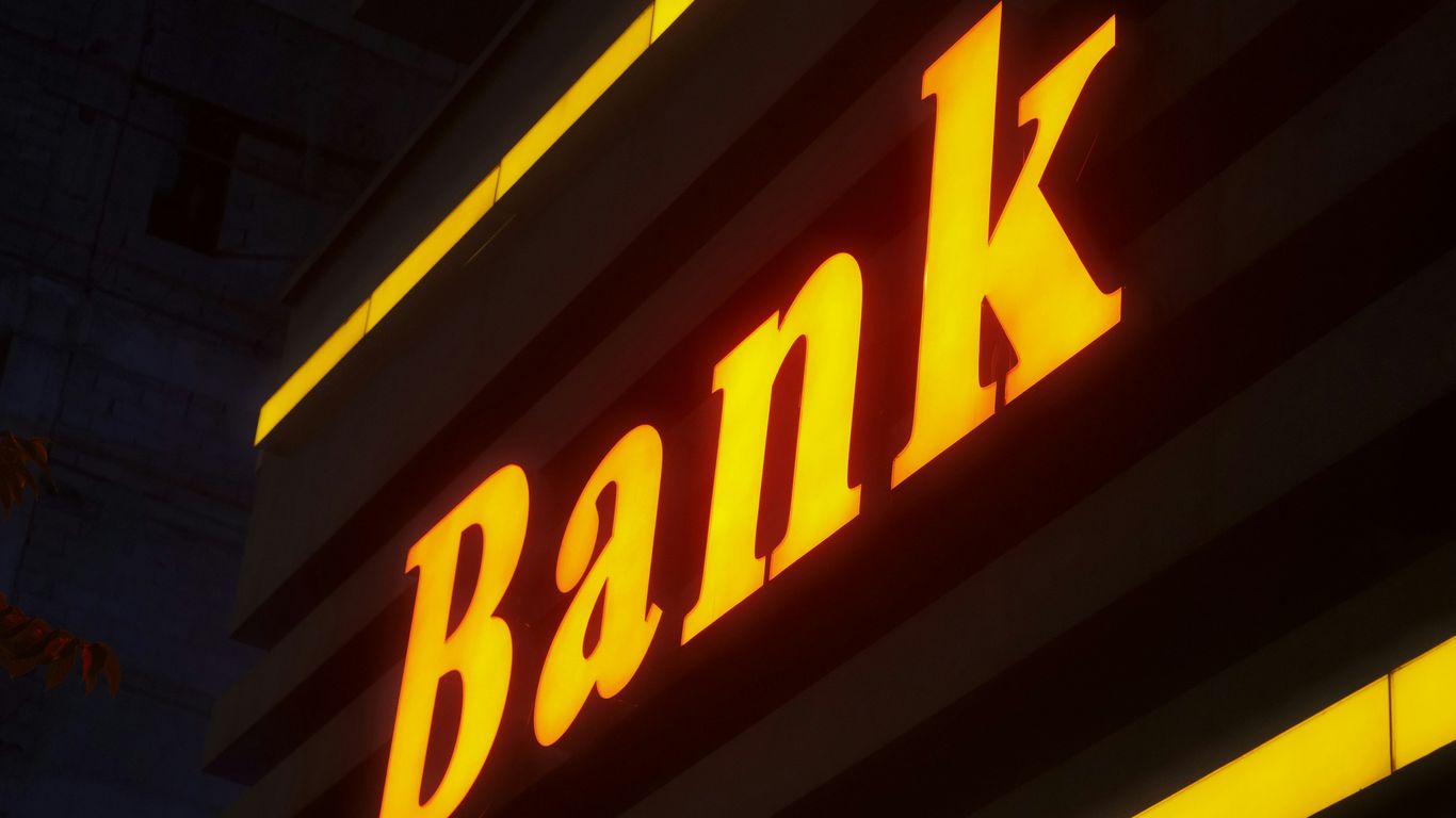 a bank sign lit up in the dark