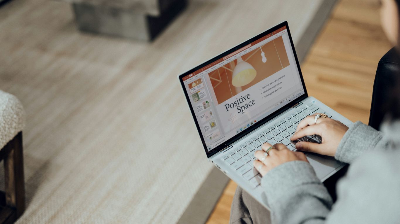 person using laptop on brown wooden table