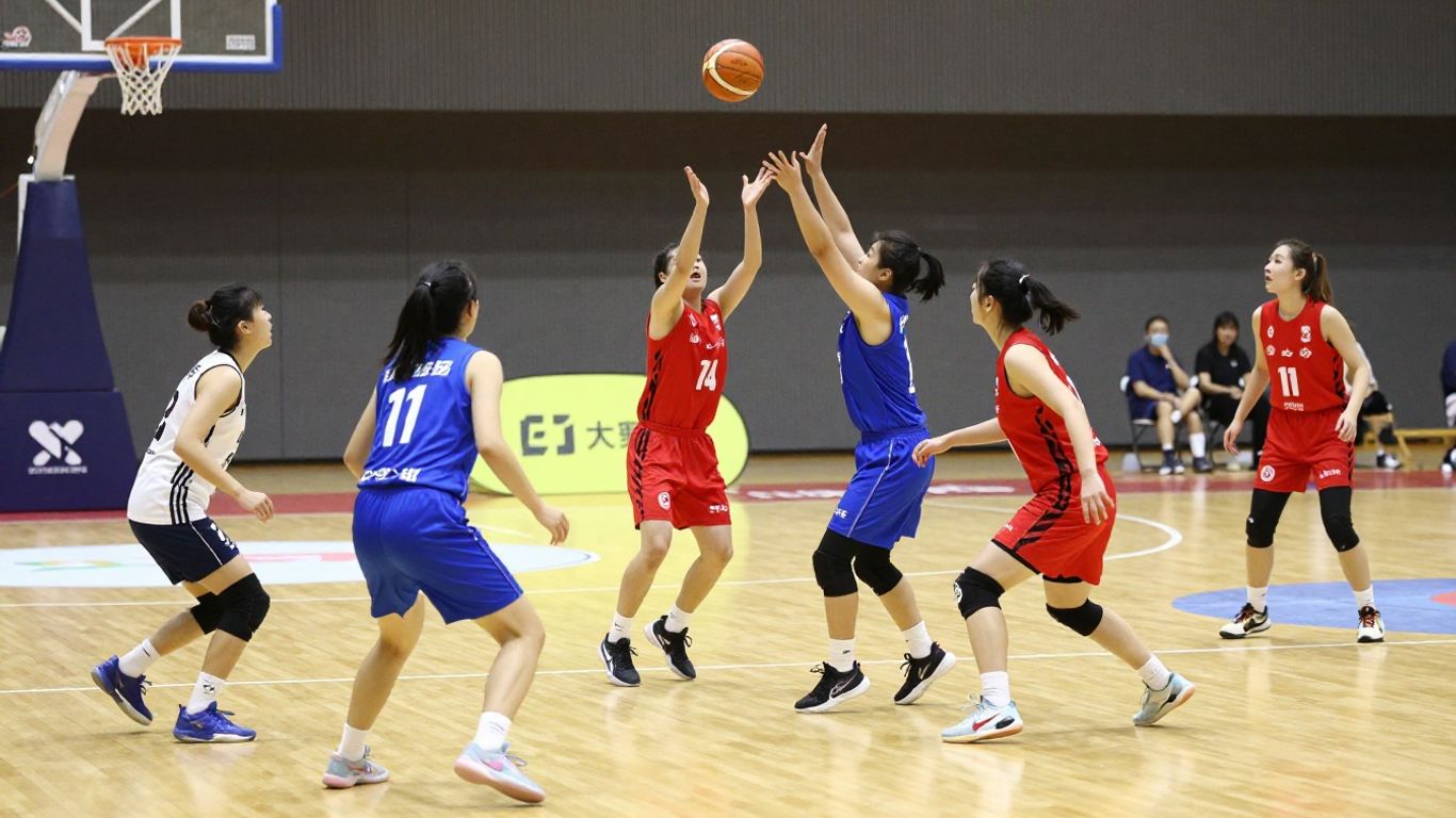 Indoor netball players in action on a court.