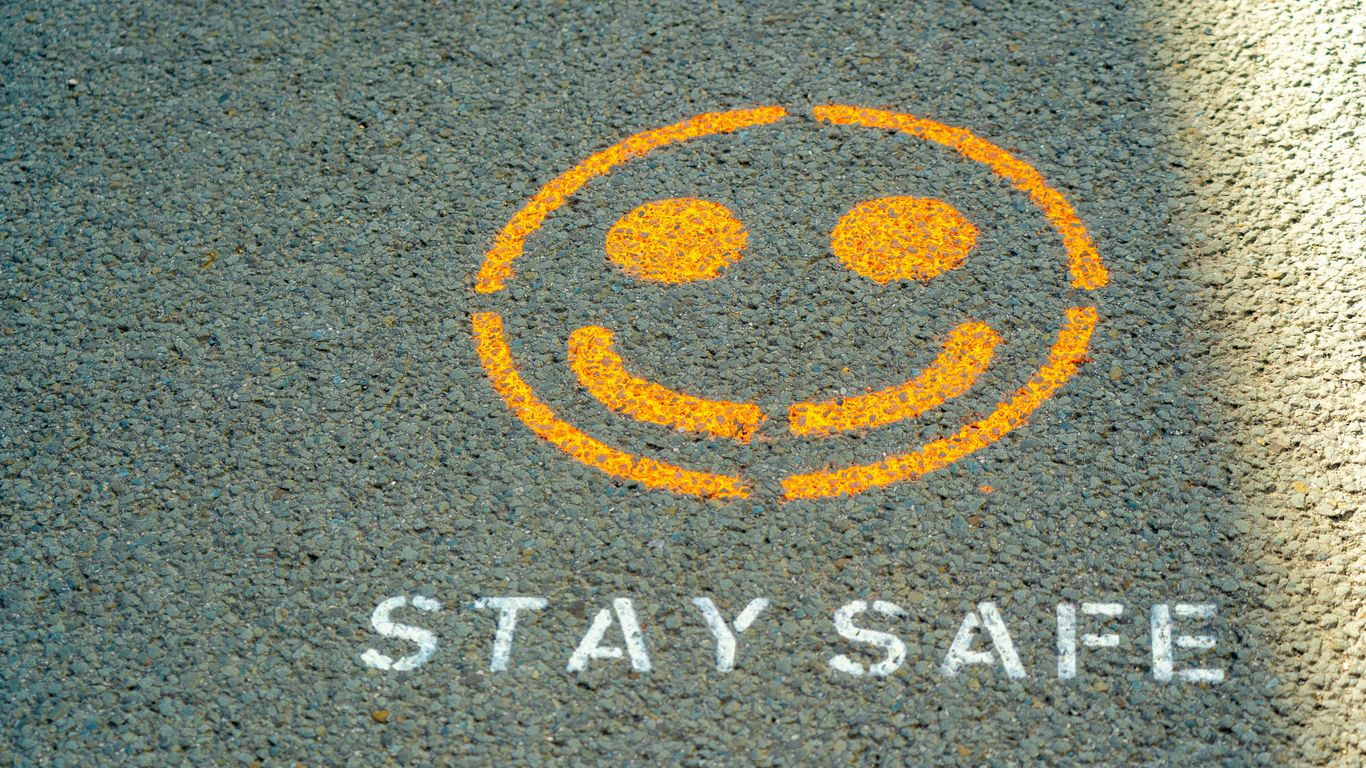 A safety sign in front of a water park pool