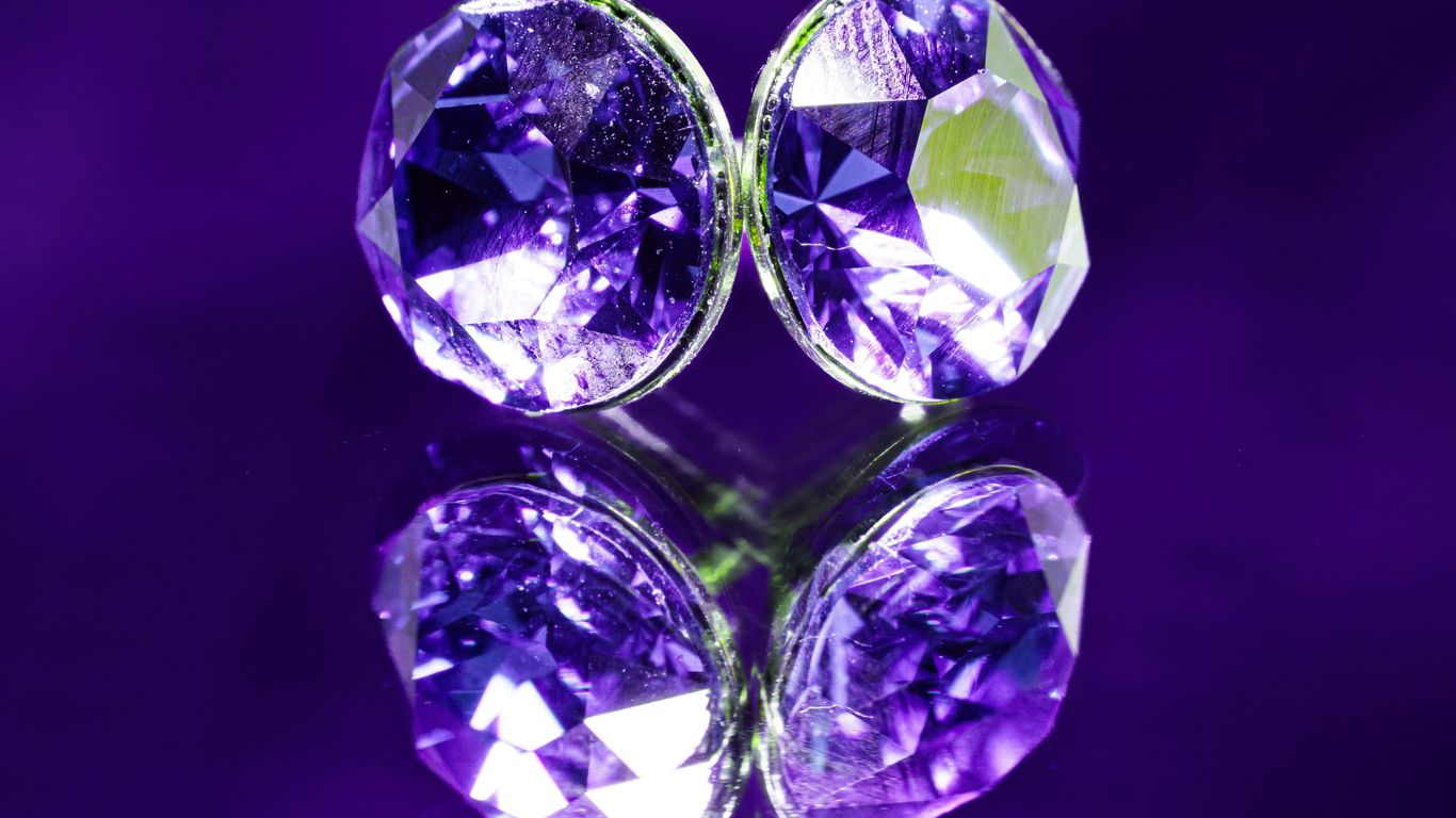 A pair of purple diamonds sitting on top of a table