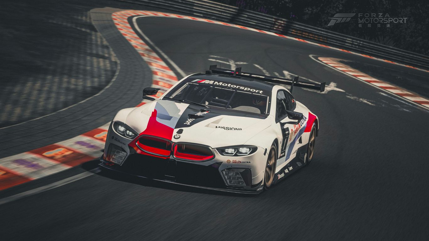 A white and red car driving on a race track