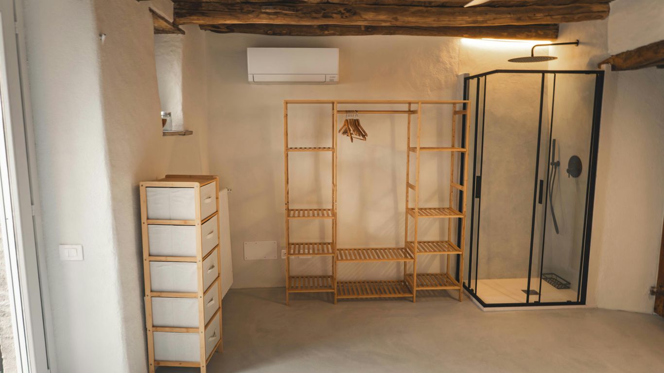 A modern bedroom with an open wardrobe.