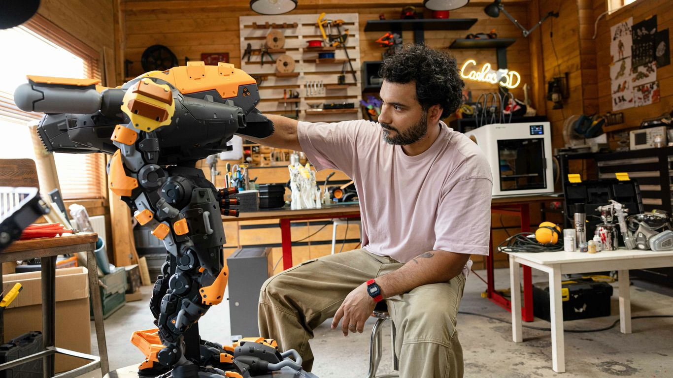 Man working on a large 3D printed sculpture.