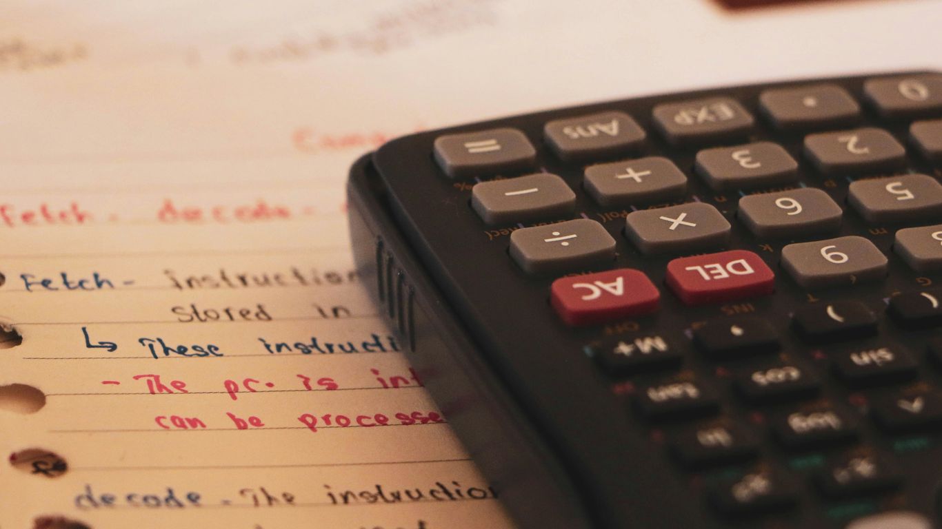a calculator sitting on top of a piece of paper