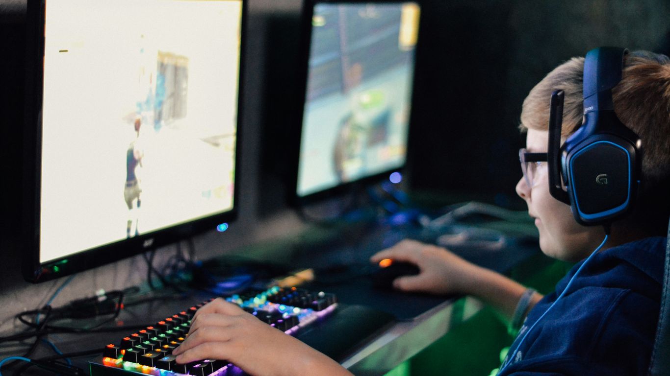 boy wearing headset playing computer game