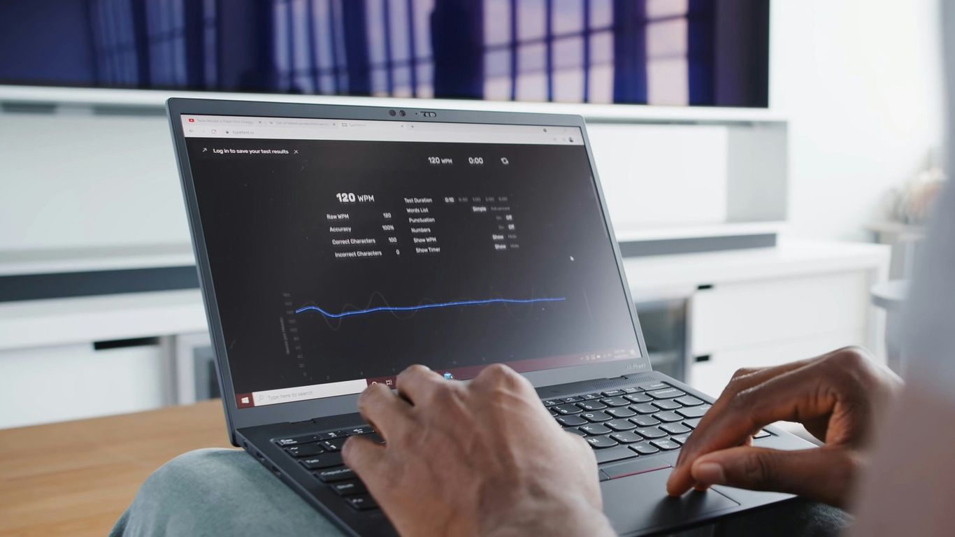a person sitting in front of a laptop computer