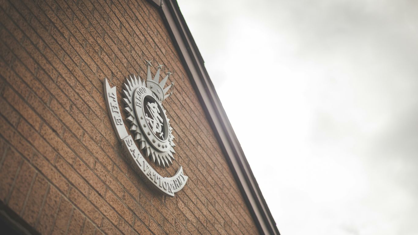 brown brick wall with black and white logo