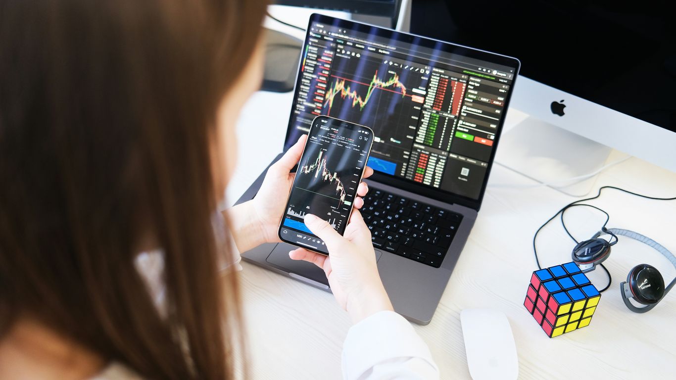 a woman sitting at a desk using a laptop computer