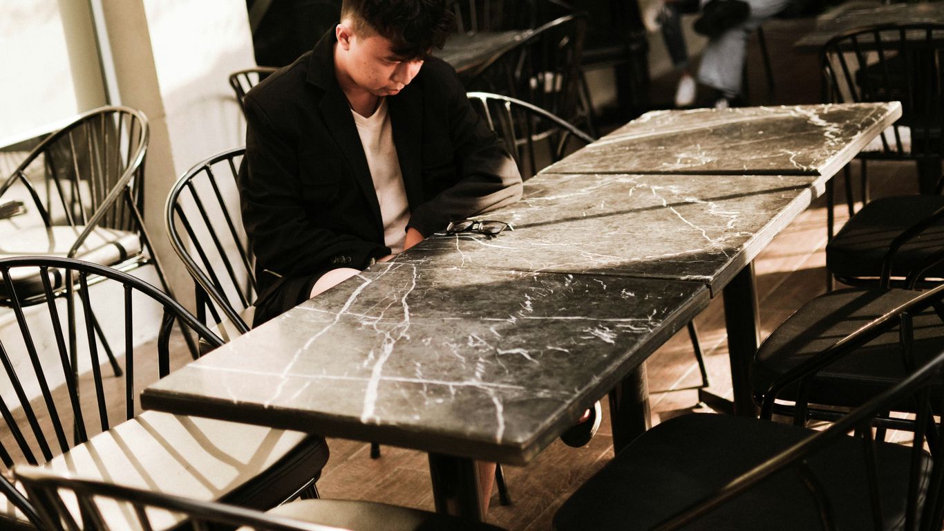 Guests seated around oval marble table