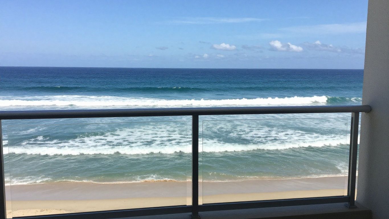 A modern apartment balcony overlooking the blue ocean