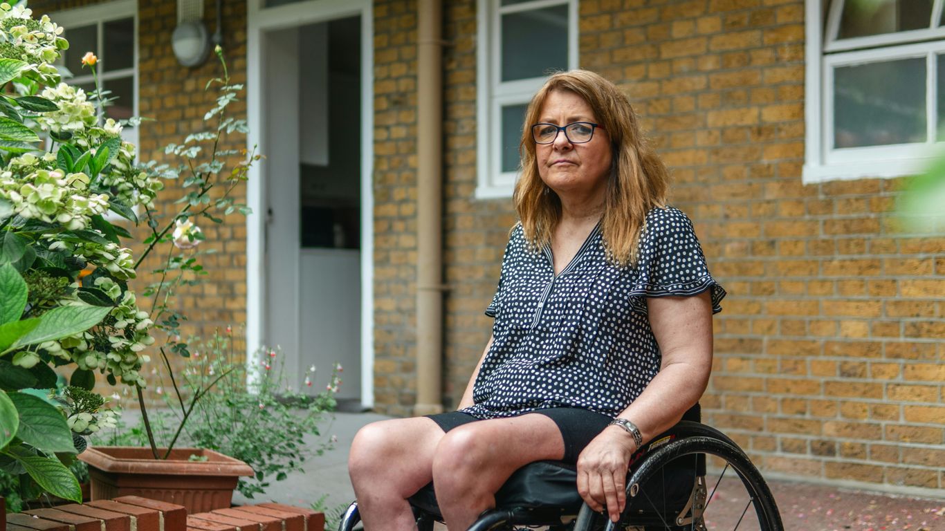 Woman in wheelchair outside brick building