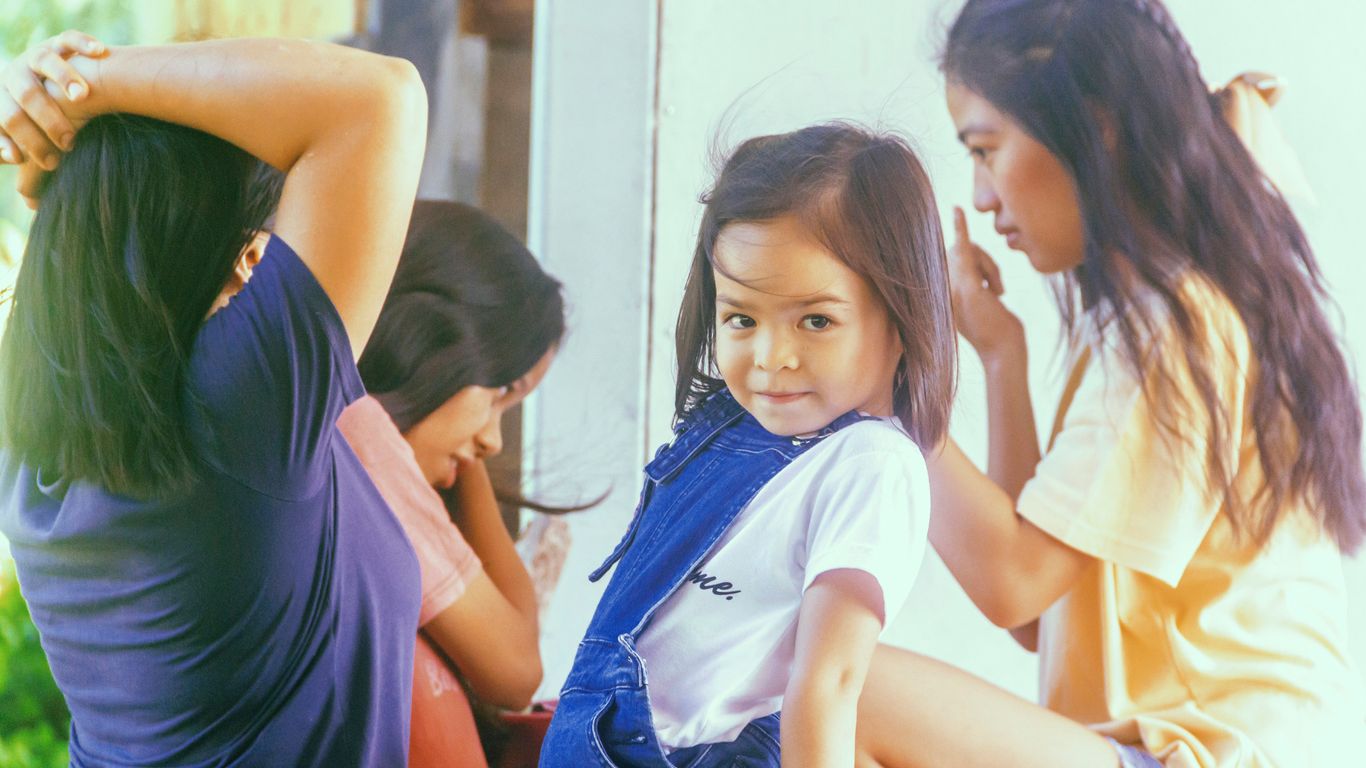 girl in white t-shirt sitting on floor