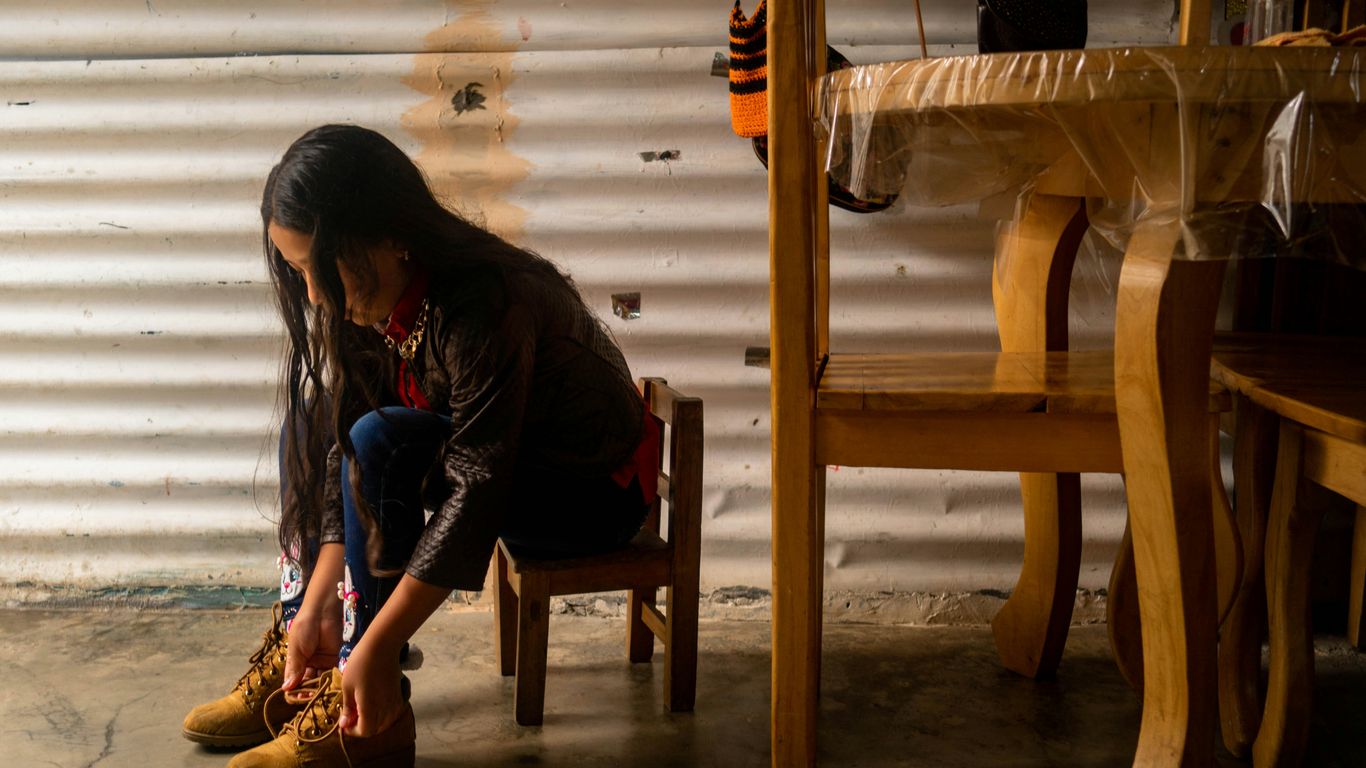A child learning to tie their shoes independently