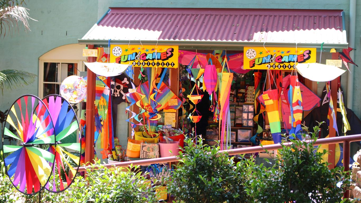 a store front with a bunch of colorful umbrellas